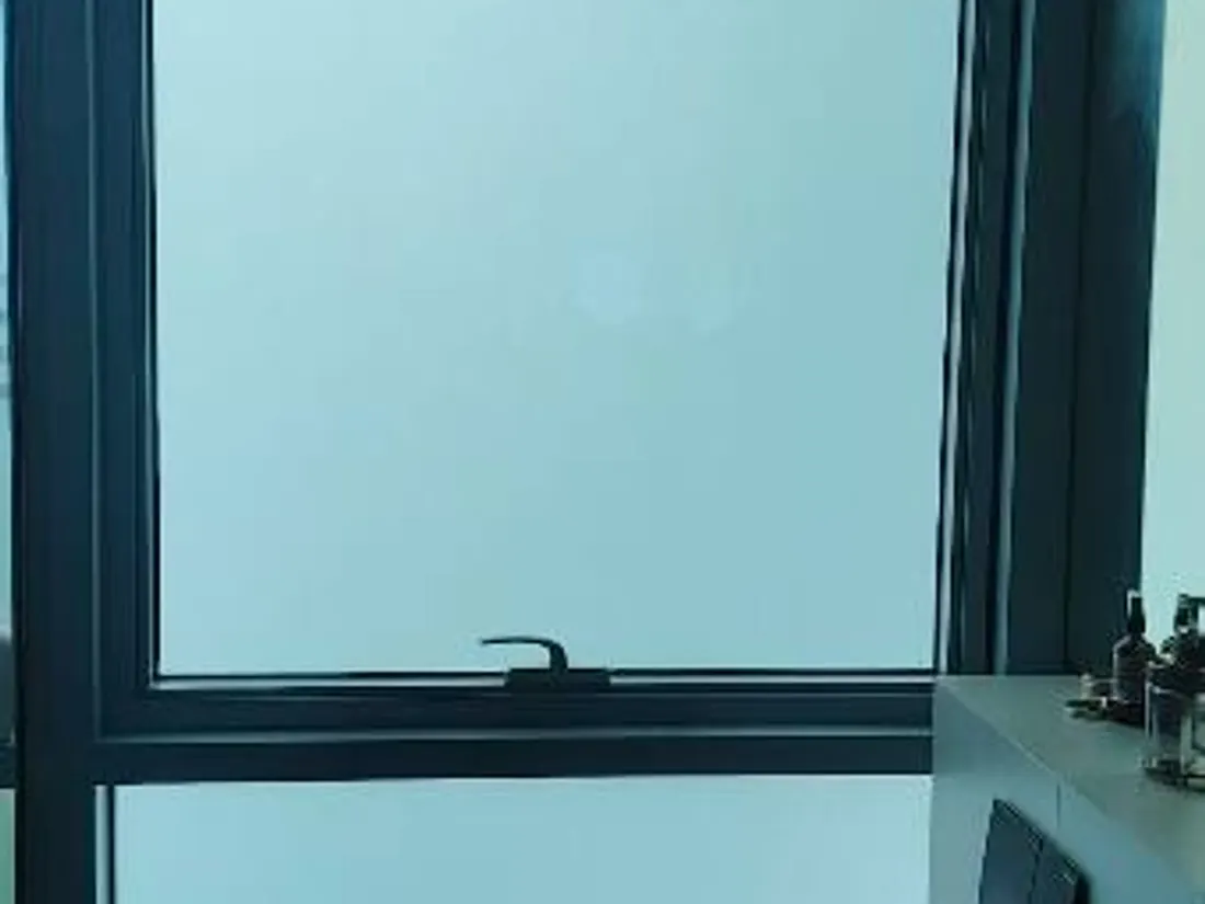 A residential bathroom window in Singapore with Smart Film applied, switched frosted for privacy