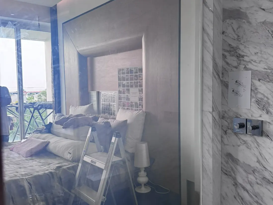 Smart Glass partition between a Sentosa bedroom and marble bathroom, switched clear