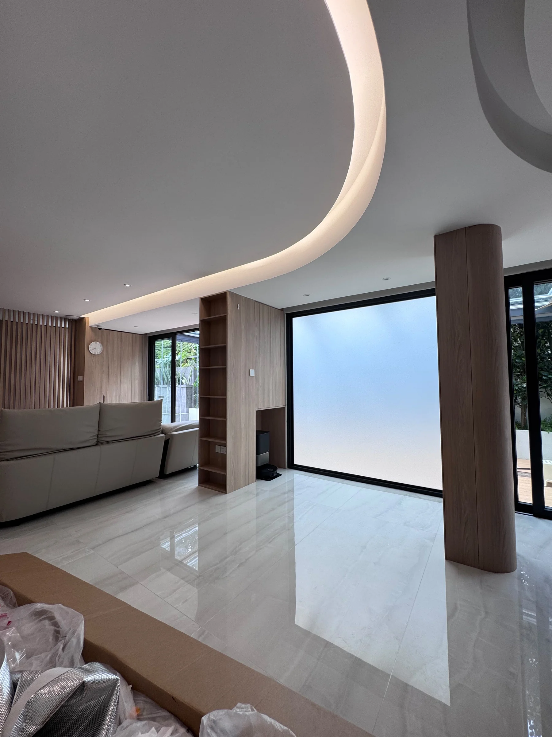 The same living room glass with switchable smart film in private mode, the panel now frosted for privacy