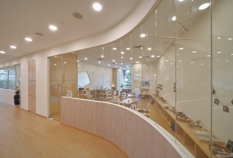Curved glass partition in a commercial interior suitable for switchable smart film