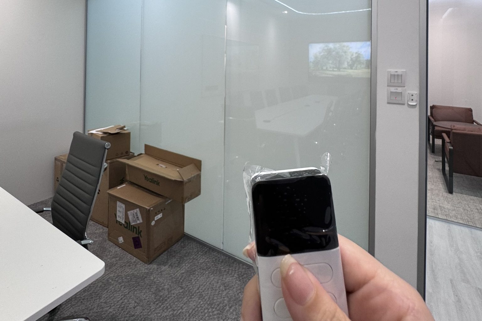 Existing glass with smart film being tested by remote before installation planning