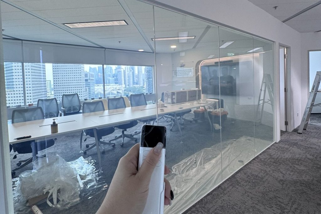 Smart film installed on an office meeting room glass partition for controllable privacy