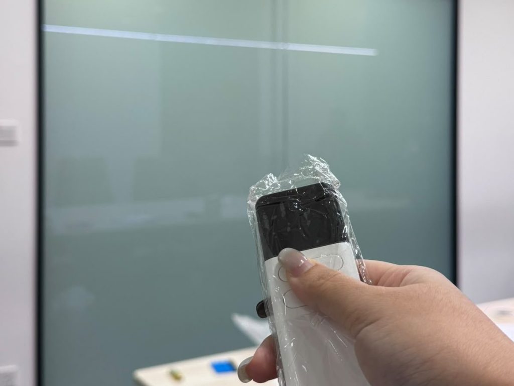 Remote control operating smart film on a glass partition