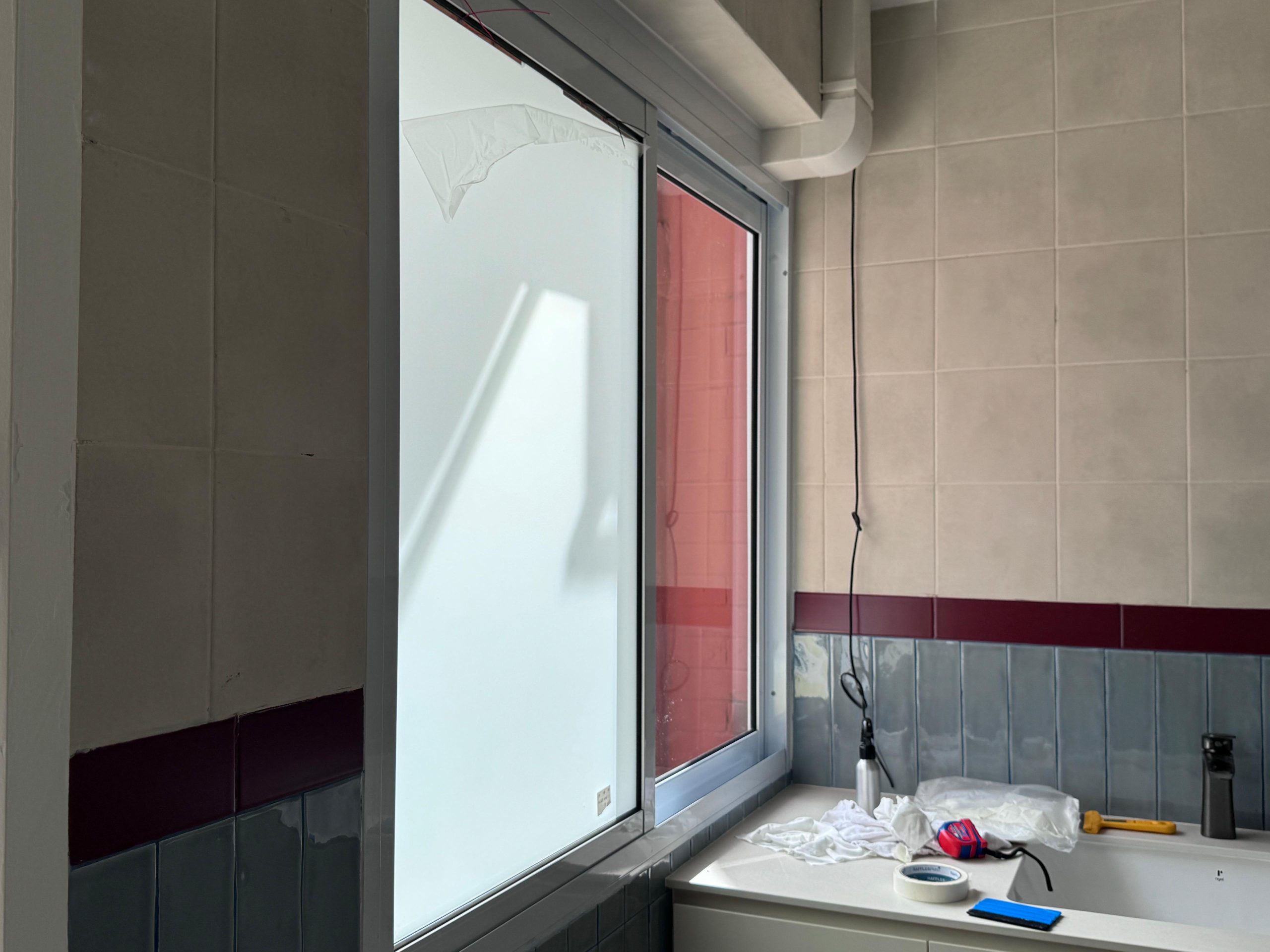 Smart film applied to an existing glass window for switchable privacy