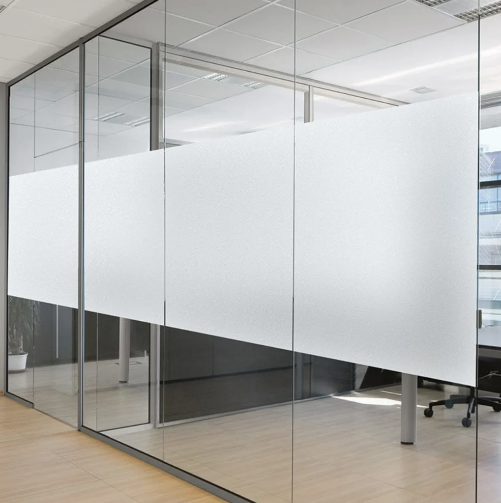 Frosted film applied as a wide privacy band across office glass partitions, keeping the space bright above and below the band