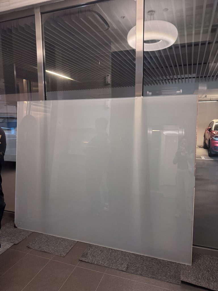 Laminated smart glass panel before installation, with the PDLC switching layer built inside the glass